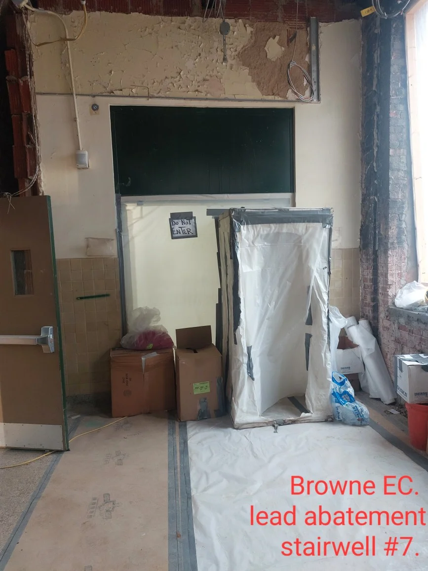 Lead abatement stairwell with plastic containment barriers and sealed work zone